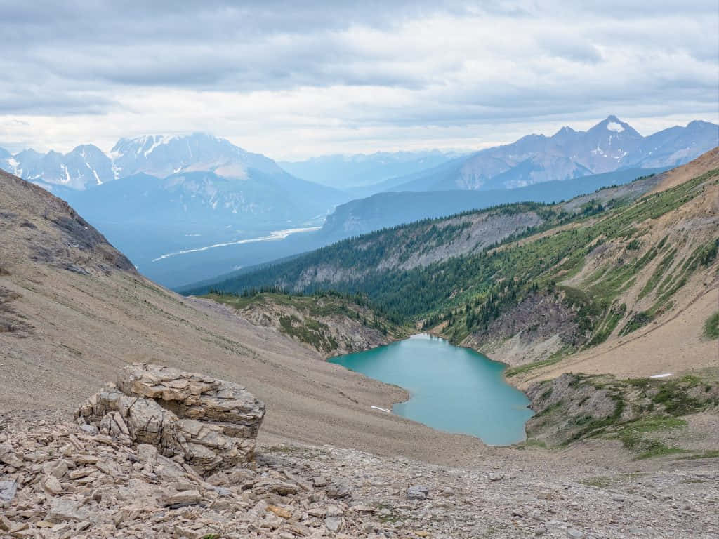 Mountainous_ Landscape_with_ Turquoise_ Lake_ View.jpg Wallpaper