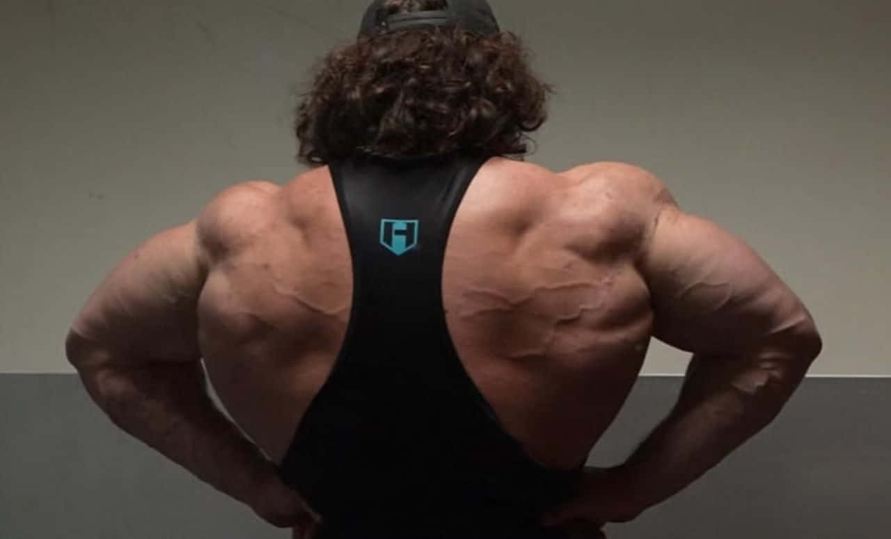 Muscular Back Pose Fitness Enthusiast Wallpaper