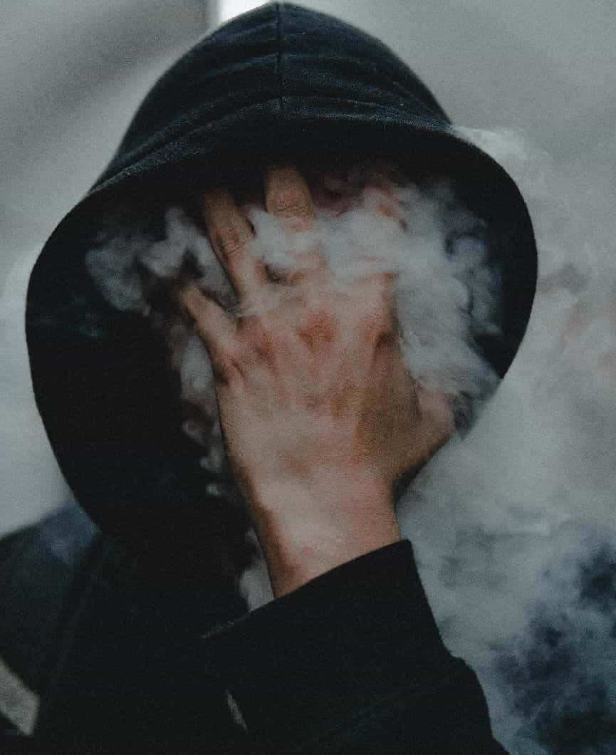 Mysterious_ Hooded_ Figure_in_ Smoke.jpg Wallpaper