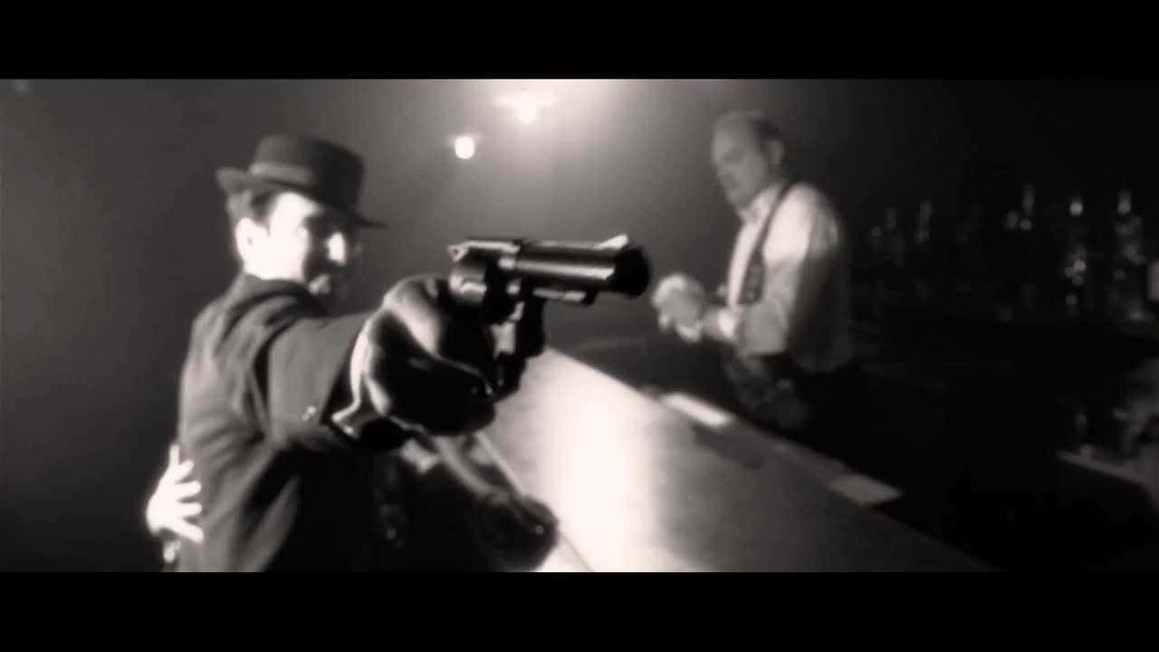 Mysterious Man Smoking In Film Noir Setting Wallpaper