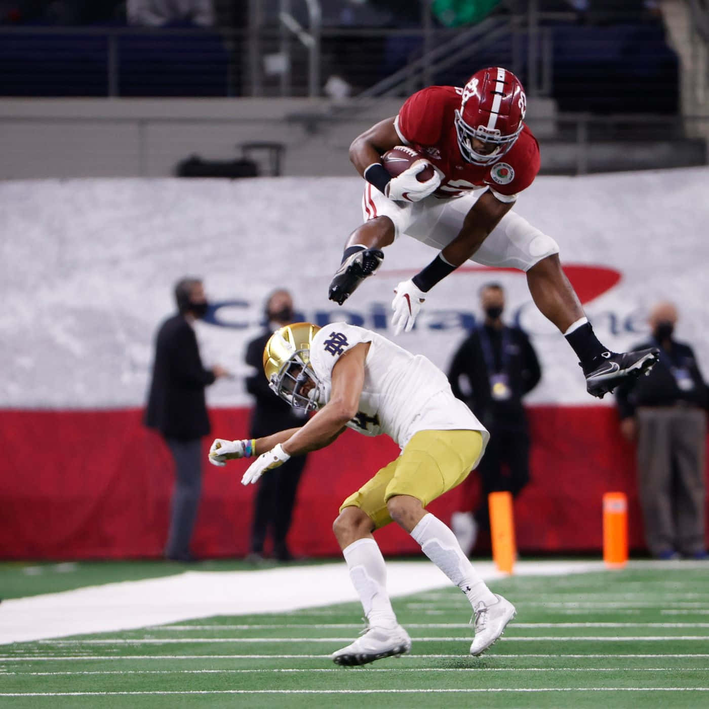 Najee Harris Athletic Jump Over Defender Wallpaper