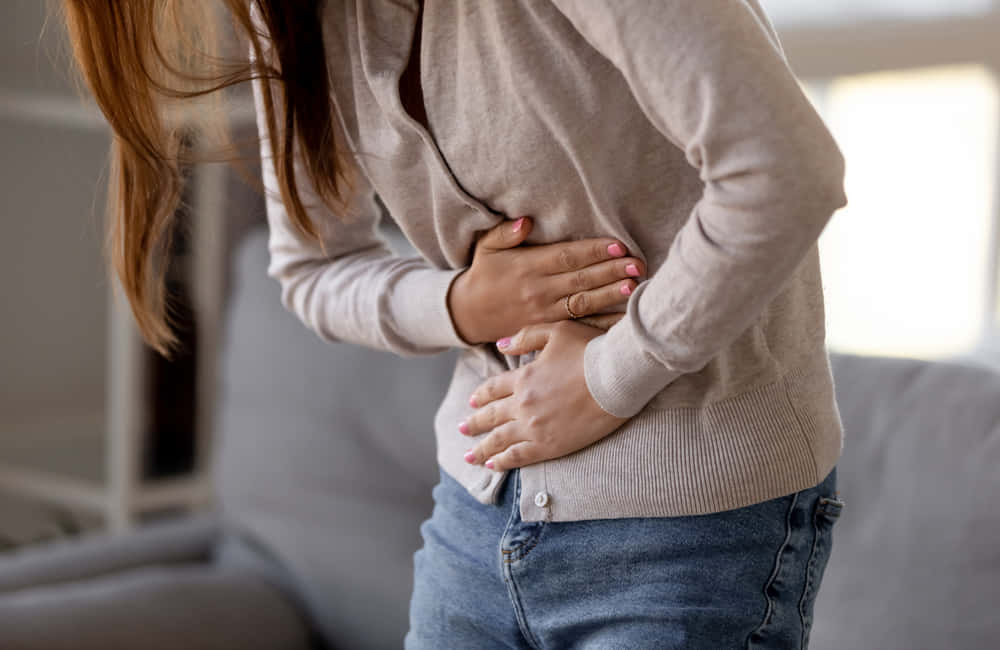 Nauseous Woman In Cream Cardigan Wallpaper