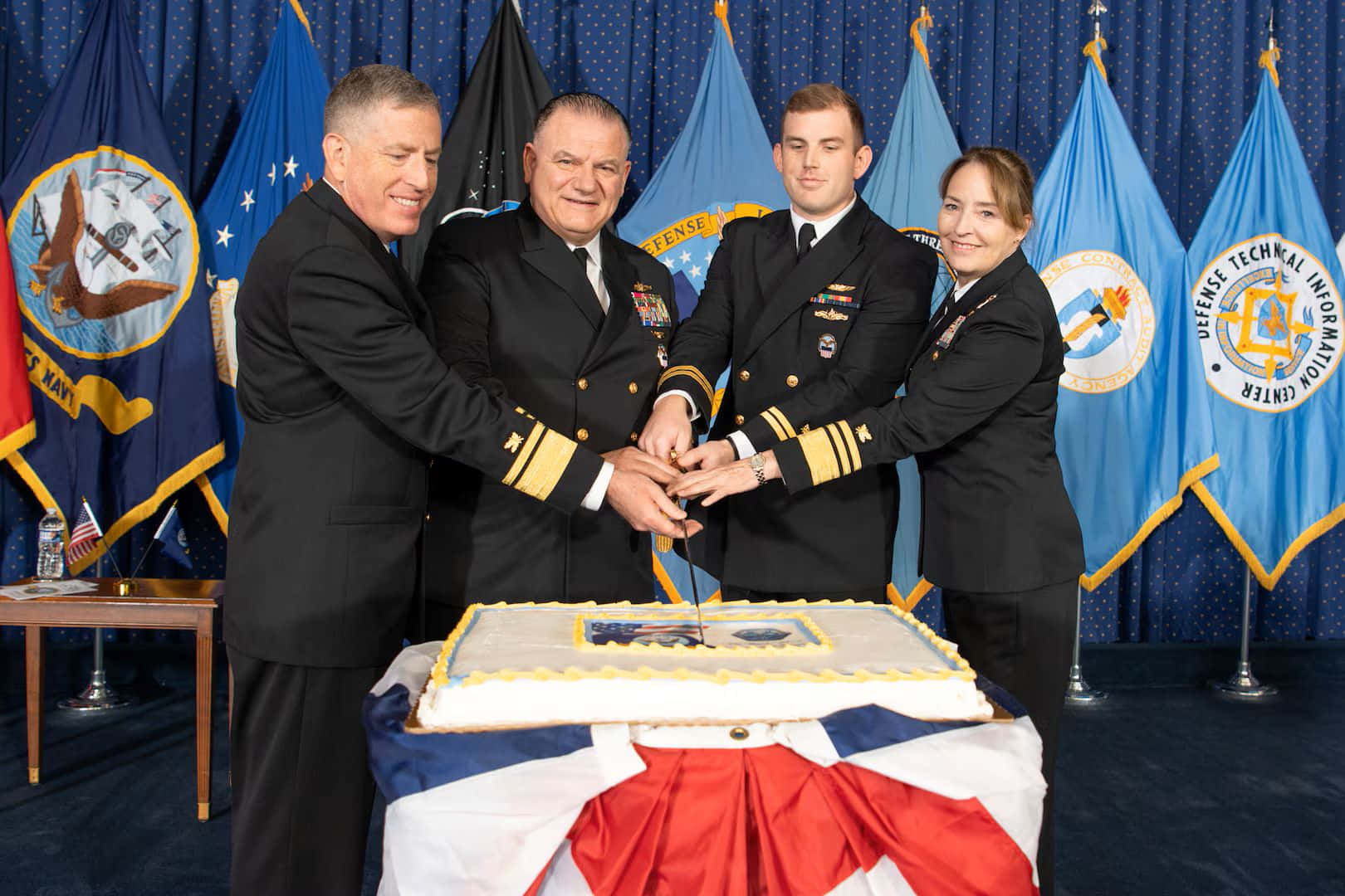 Navy Officers Celebratingwith Cake Wallpaper