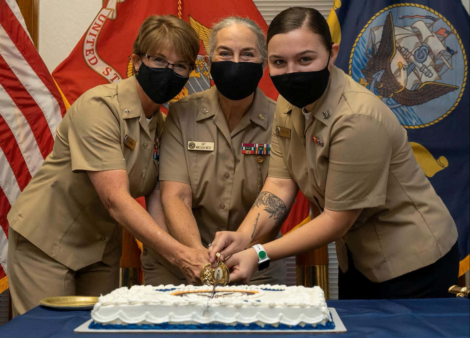 Navy Uniformed Personnel Celebratingwith Cake Wallpaper