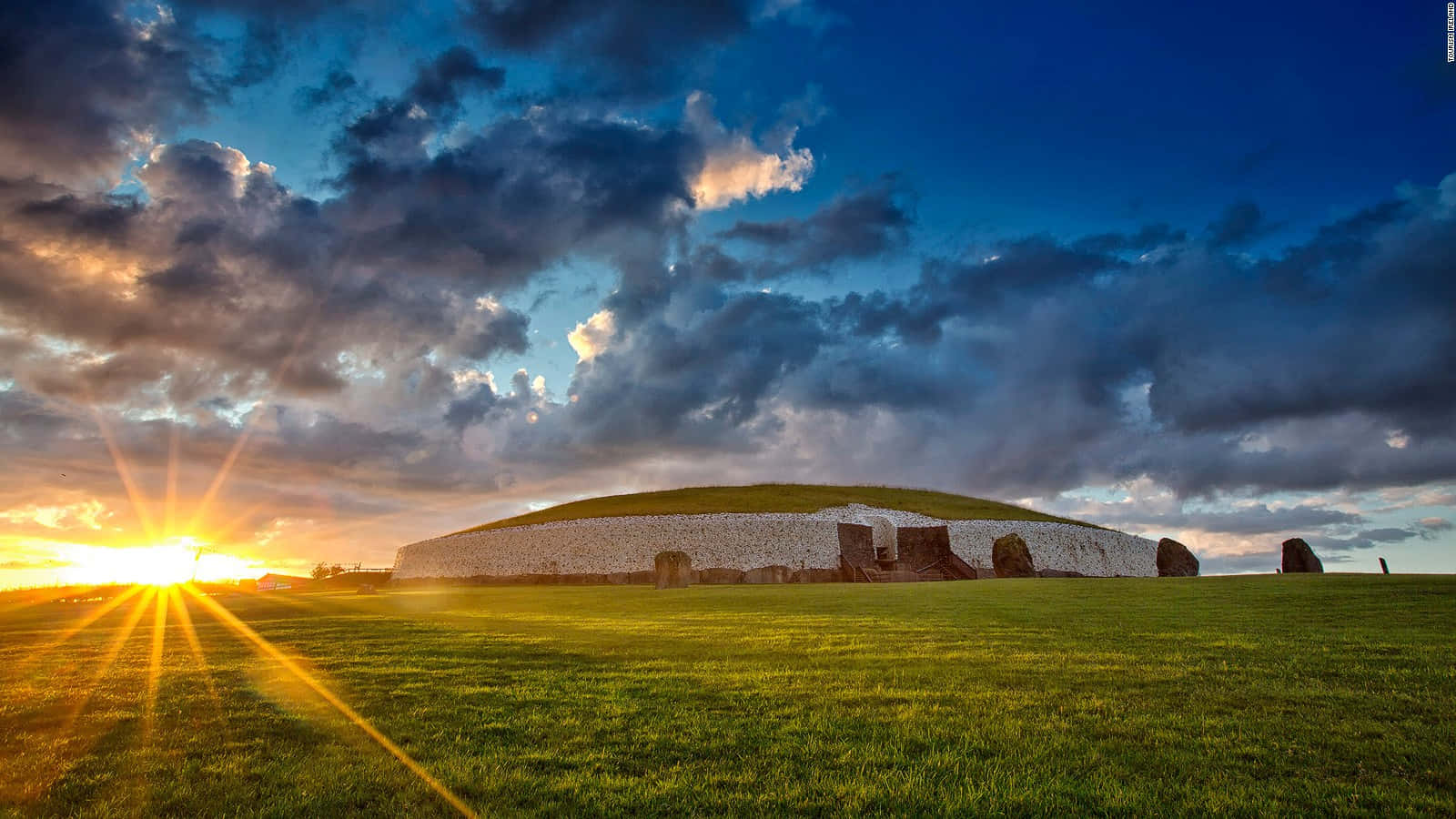 Newgrange Against The Blue Sky With Sunset Wallpaper