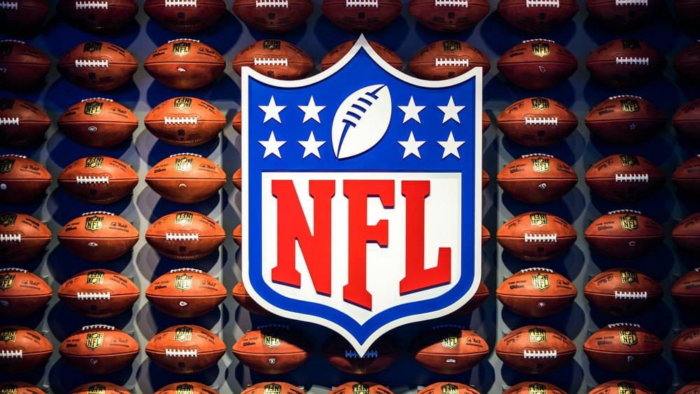 Nfl Logo With Footballs Wallpaper