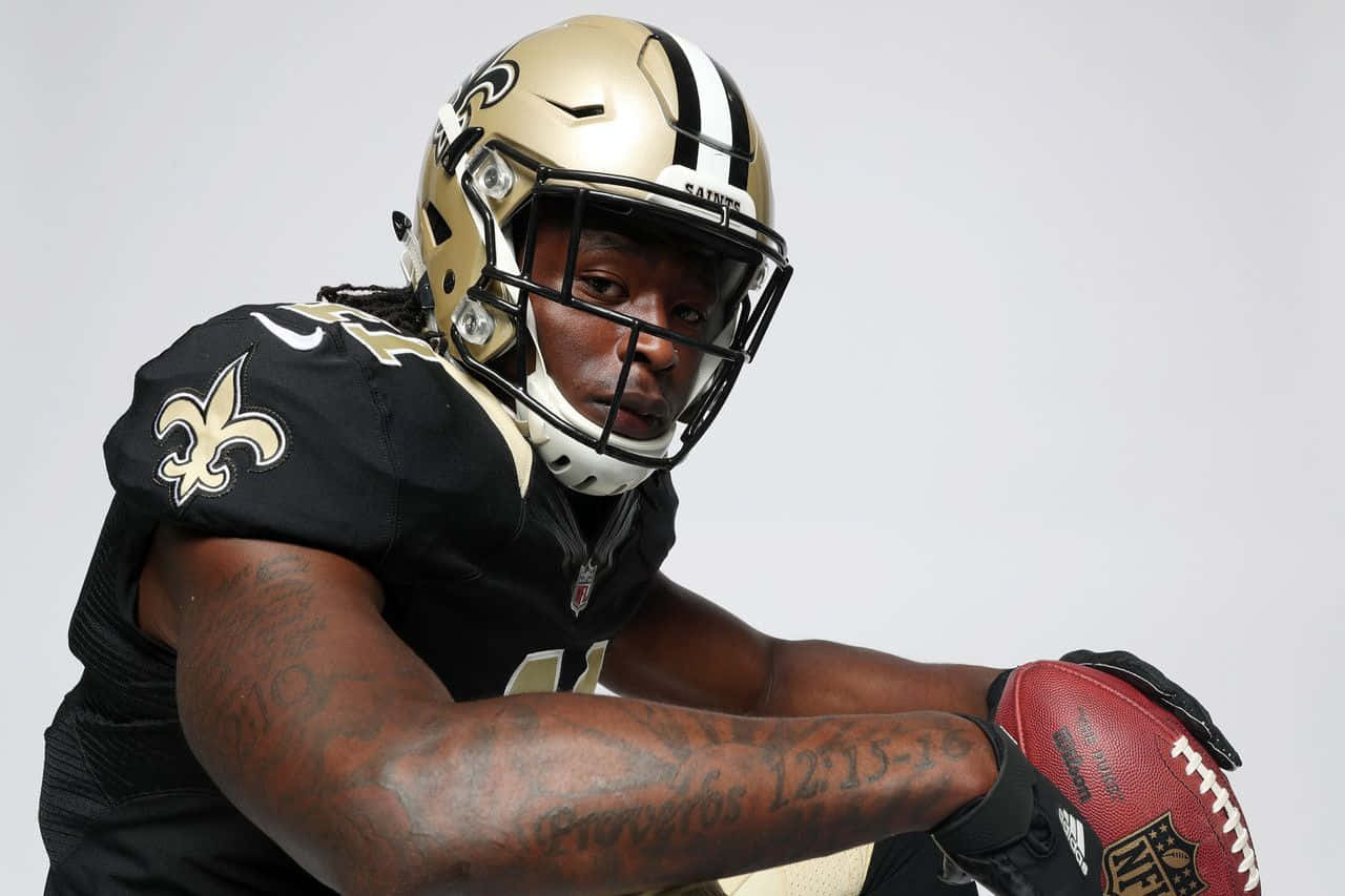 Nfl Running Back Alvin Kamara Breaks Into The Open Field Wallpaper