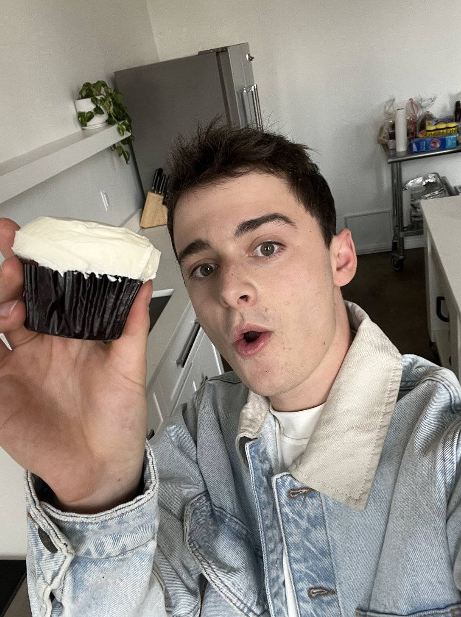 Noah Schnapp Holding A Cupcake Wallpaper