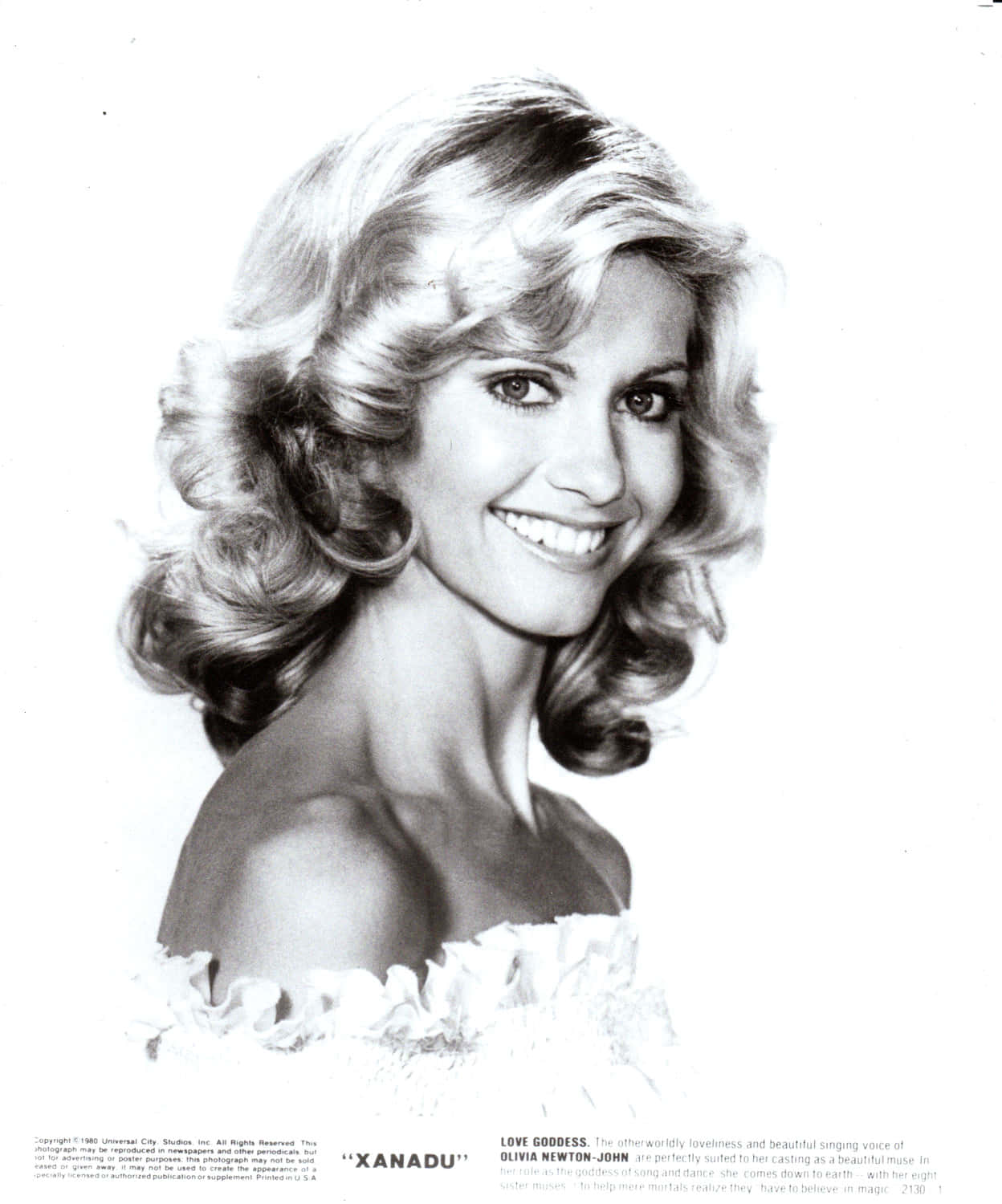 Olivia Newton John In Bright White Backdrop Wallpaper