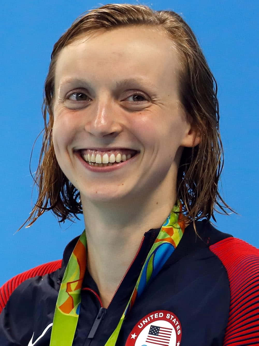 Olympic Swimmer Smiling With Medal Wallpaper