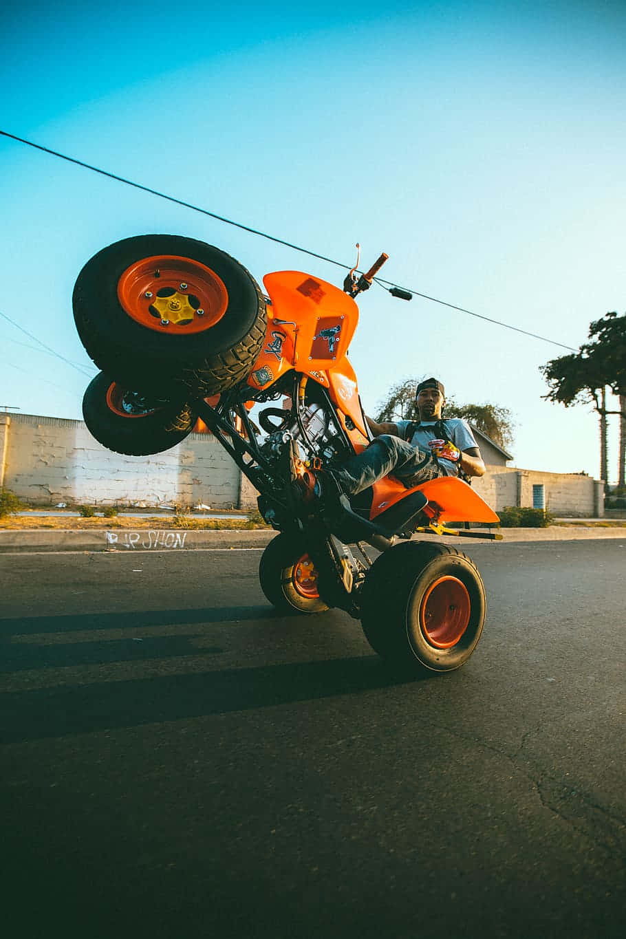 Orange A T V Wheelie Stunt Wallpaper