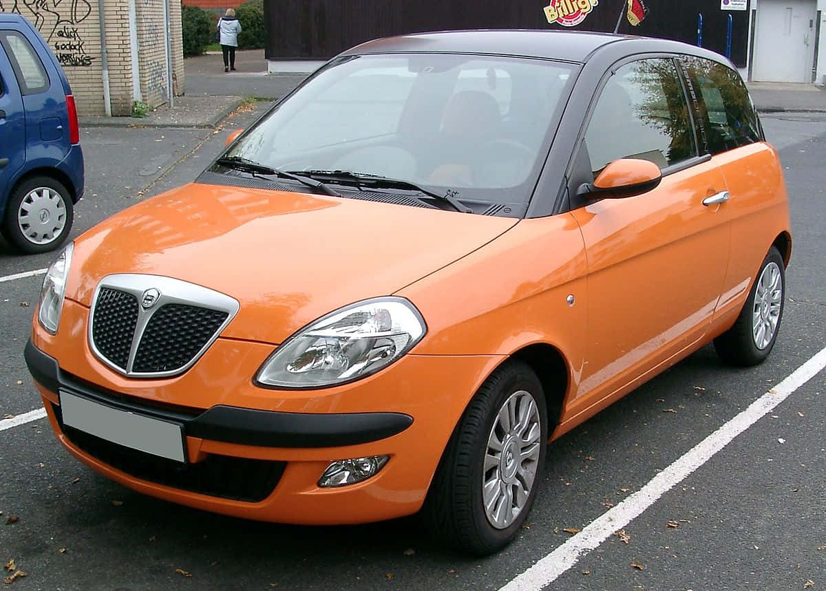 Orange Lancia Ypsilon Parked Wallpaper