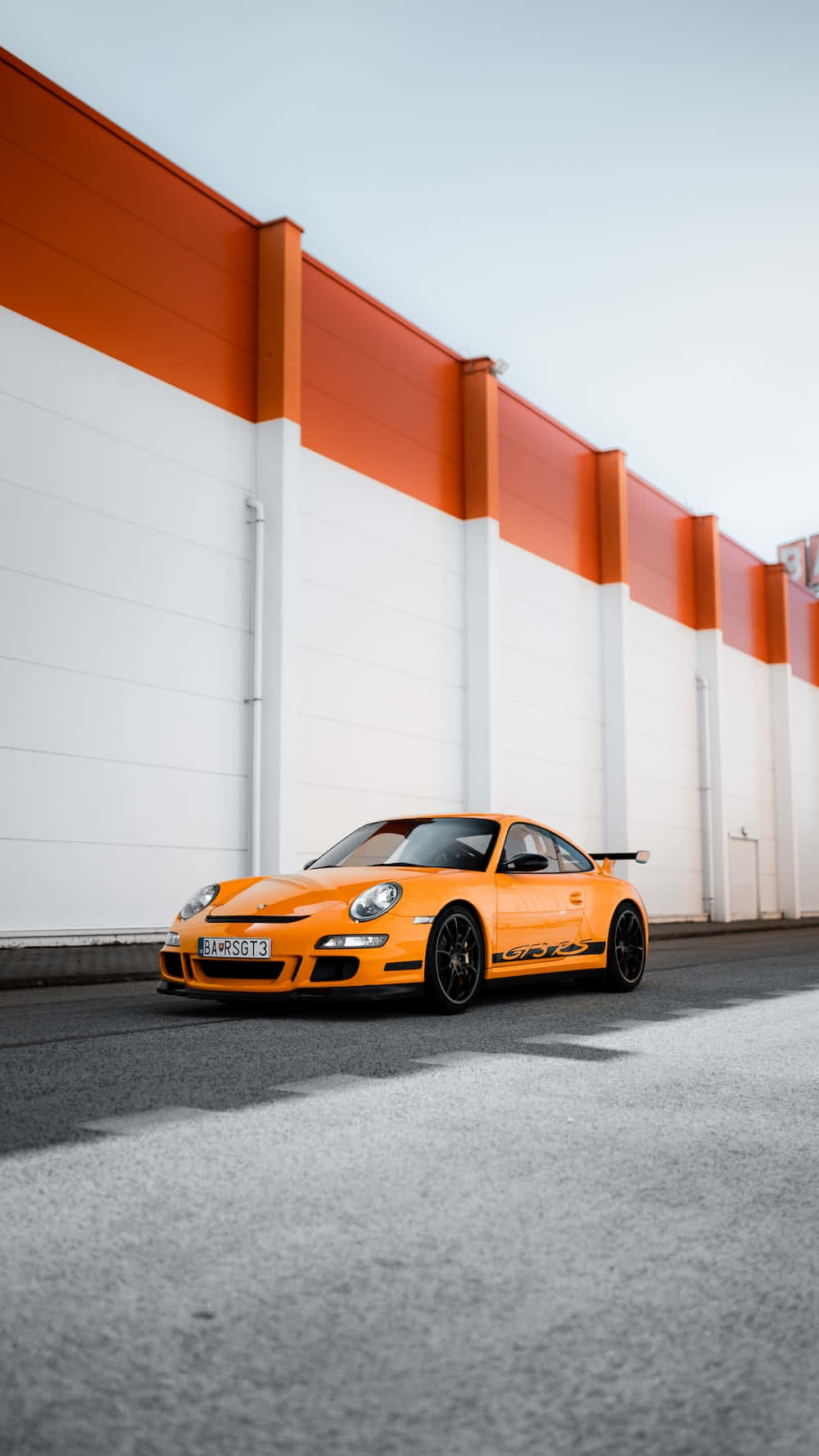 Orange Porsche G T3 R S Urban Backdrop Wallpaper