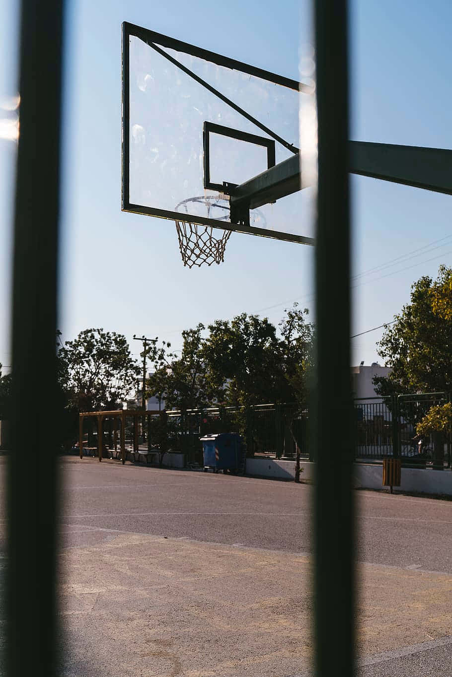 Outdoor Basketball Court Through Fence Wallpaper