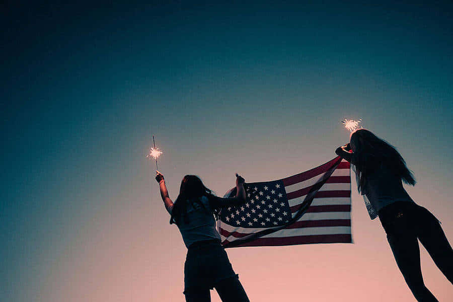 Patriotic Silhouetteswith Sparklersand American Flag Wallpaper