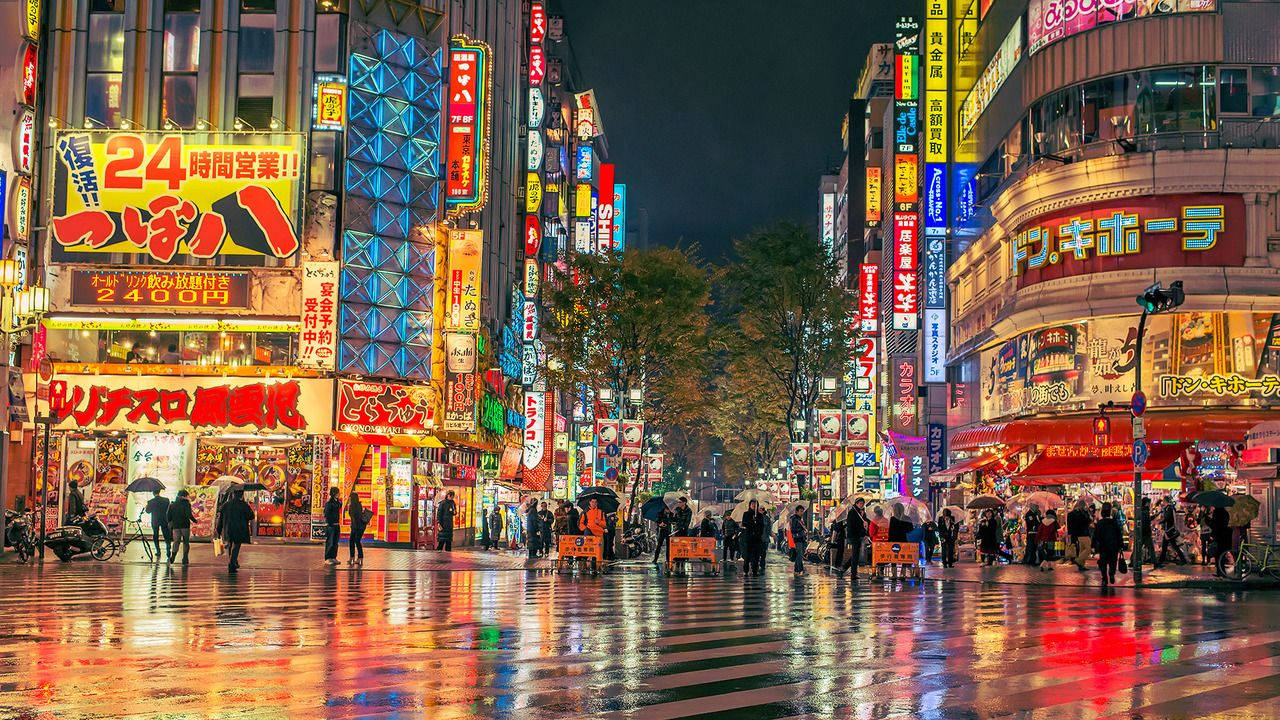 People Gathering At The World-famous Shibuya Crossing In Tokyo Wallpaper