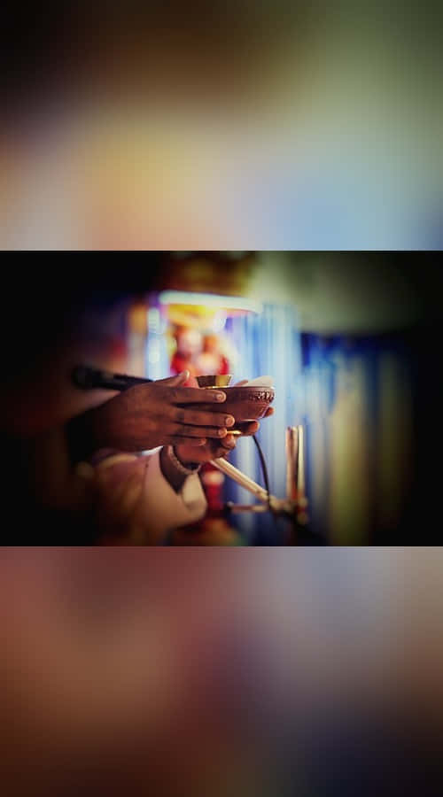 Person Holding A Chalice During A Sacrament Ceremony Wallpaper