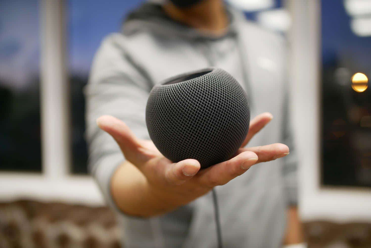 Person Holding Black Homepod Mini Wallpaper