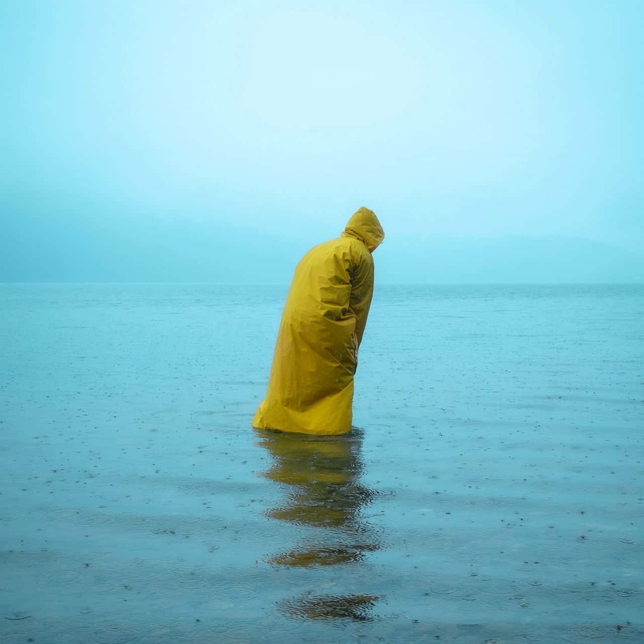 Person Wearing A Yellow Raincoat Wallpaper