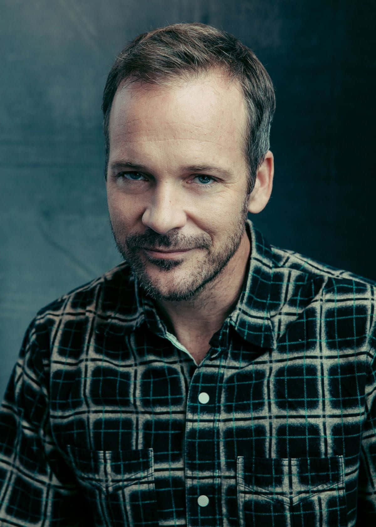 Peter Sarsgaard Staring Into The Camera. Wallpaper