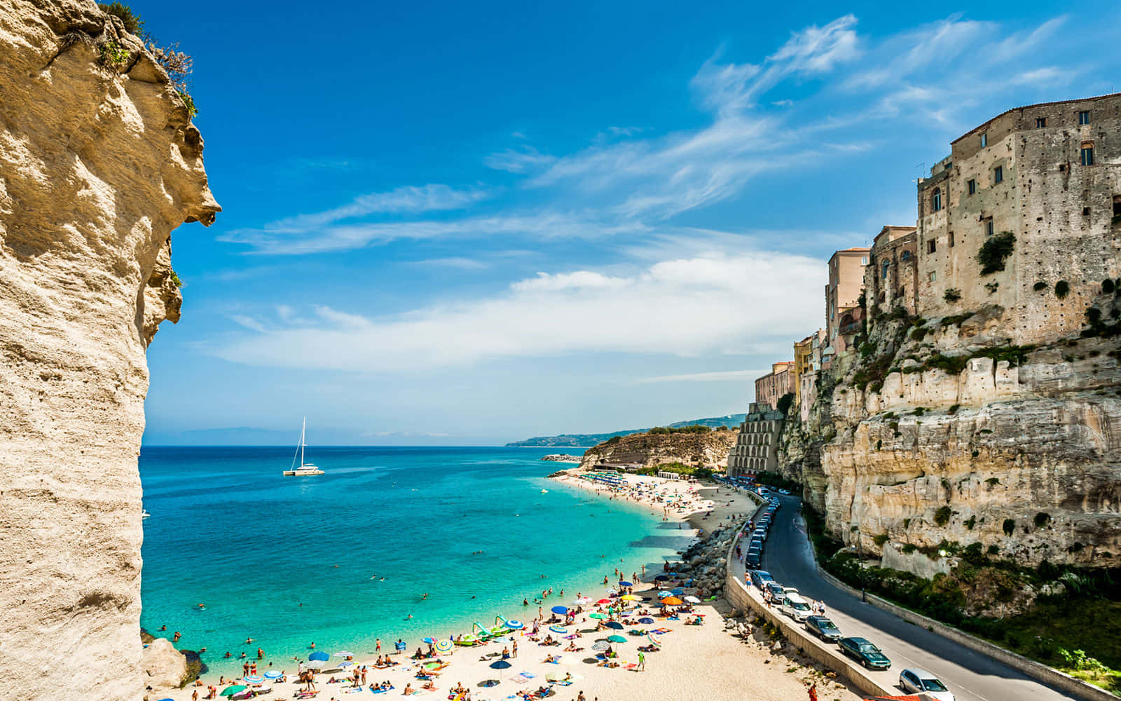 Picturesque Italian Beach With Turquoise Waters And Lush Greenery Wallpaper