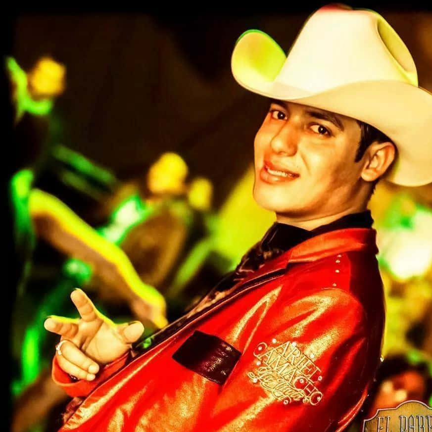 Popular Banda Sinaloense Singer Ariel Camacho Performing For An Audience. Wallpaper