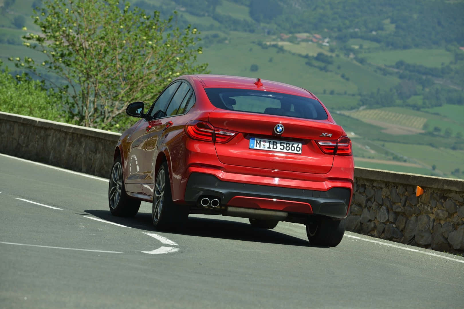 Powerful And Refined - The Bmw X4 In Its Elegant Stance Wallpaper