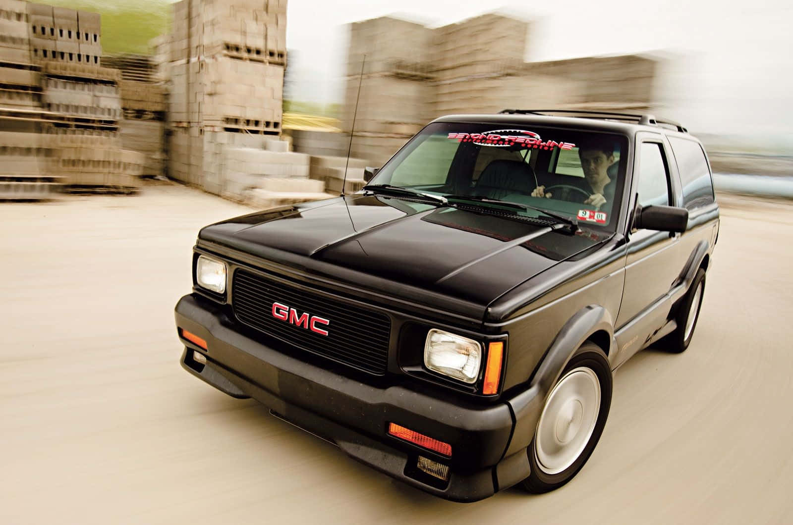 Powerful Gmc Syclone Speeding Down The Road Wallpaper