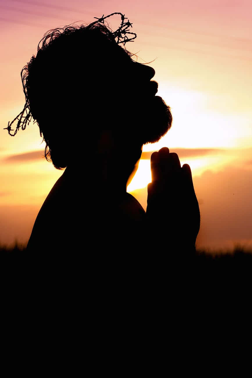 Prayerful Silhouette At Sunset.jpg Wallpaper