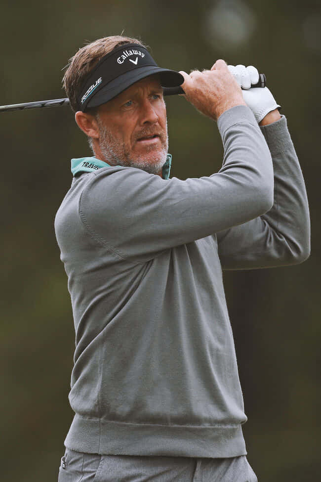 Pro Golfer Stuart Appleby Donning A Stylish Gray Sweater Wallpaper