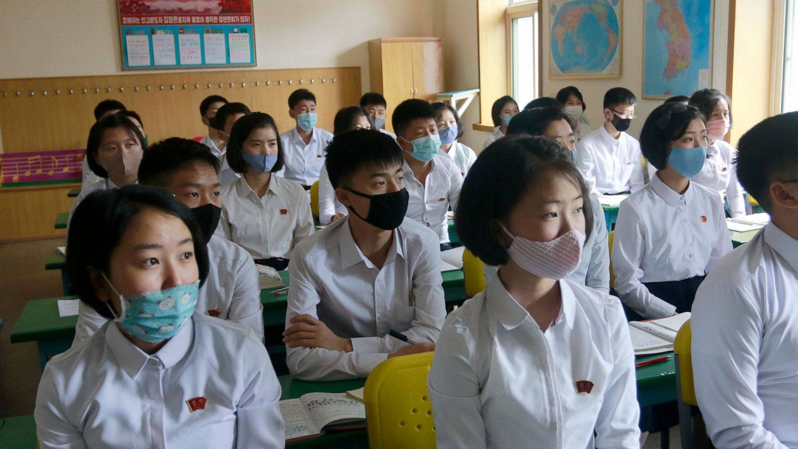 Professional In Medical Protective Gear Holding A Test Kit For Coronavirus Wallpaper