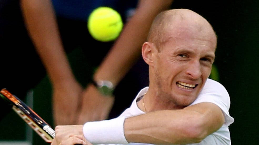 Professional Tennis Player Nikolay Davydenko Squinting In The Sun Wallpaper