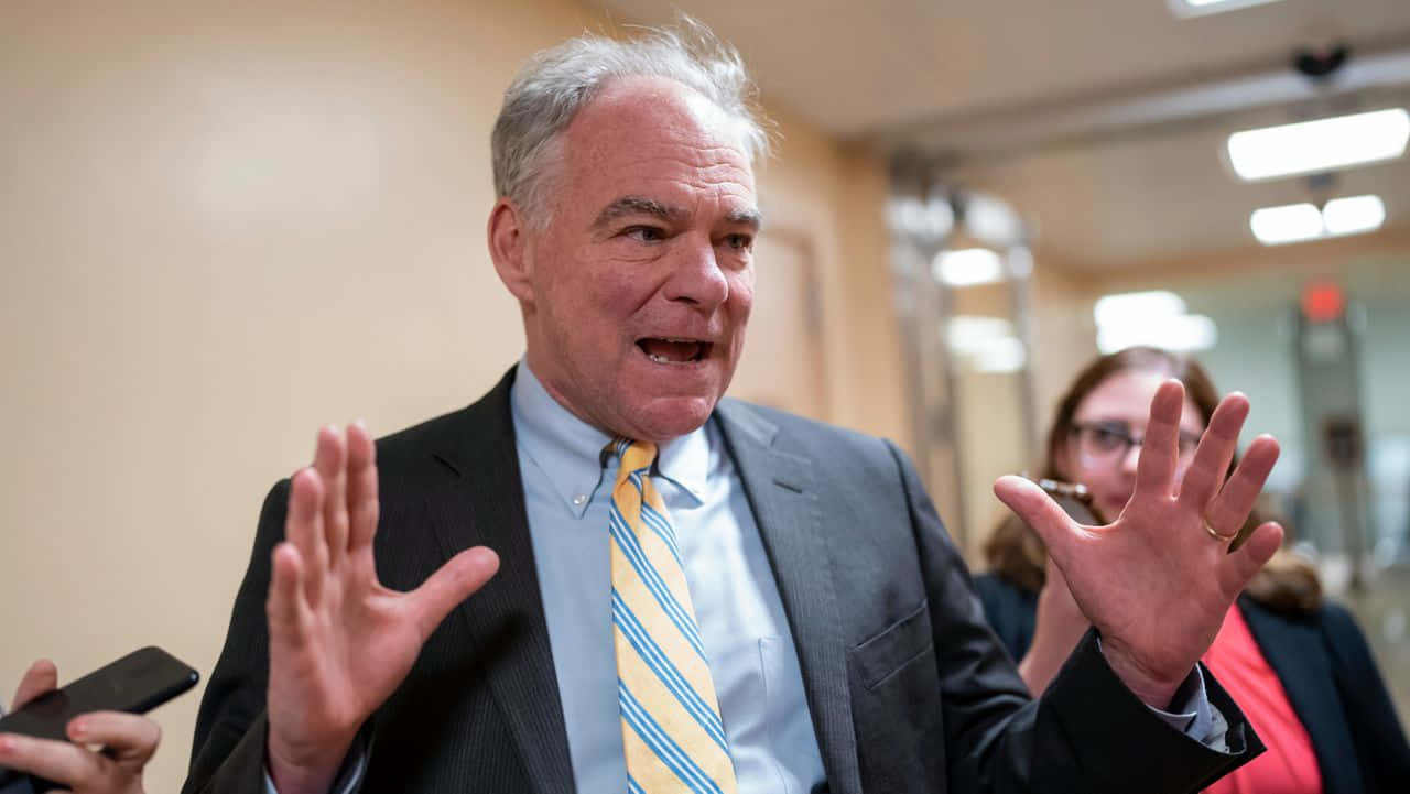 Prominent American Politician Tim Kaine In A Striped Tie. Wallpaper