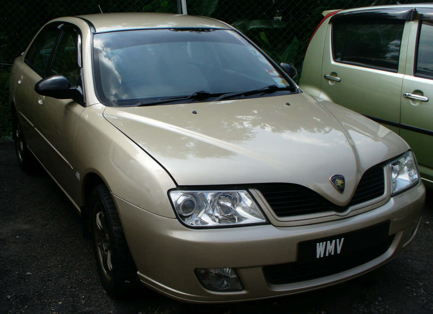 Proton Waja Golden Sedan Parked Wallpaper