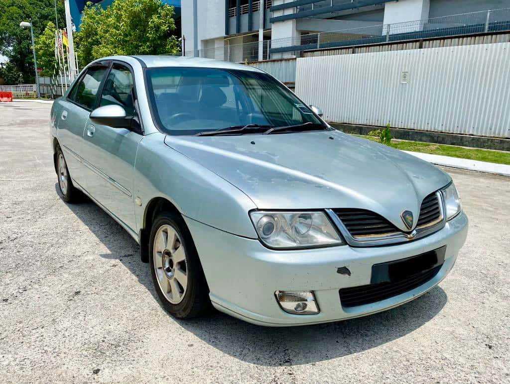 Proton Waja Silver Sedan Parked Outdoors Wallpaper