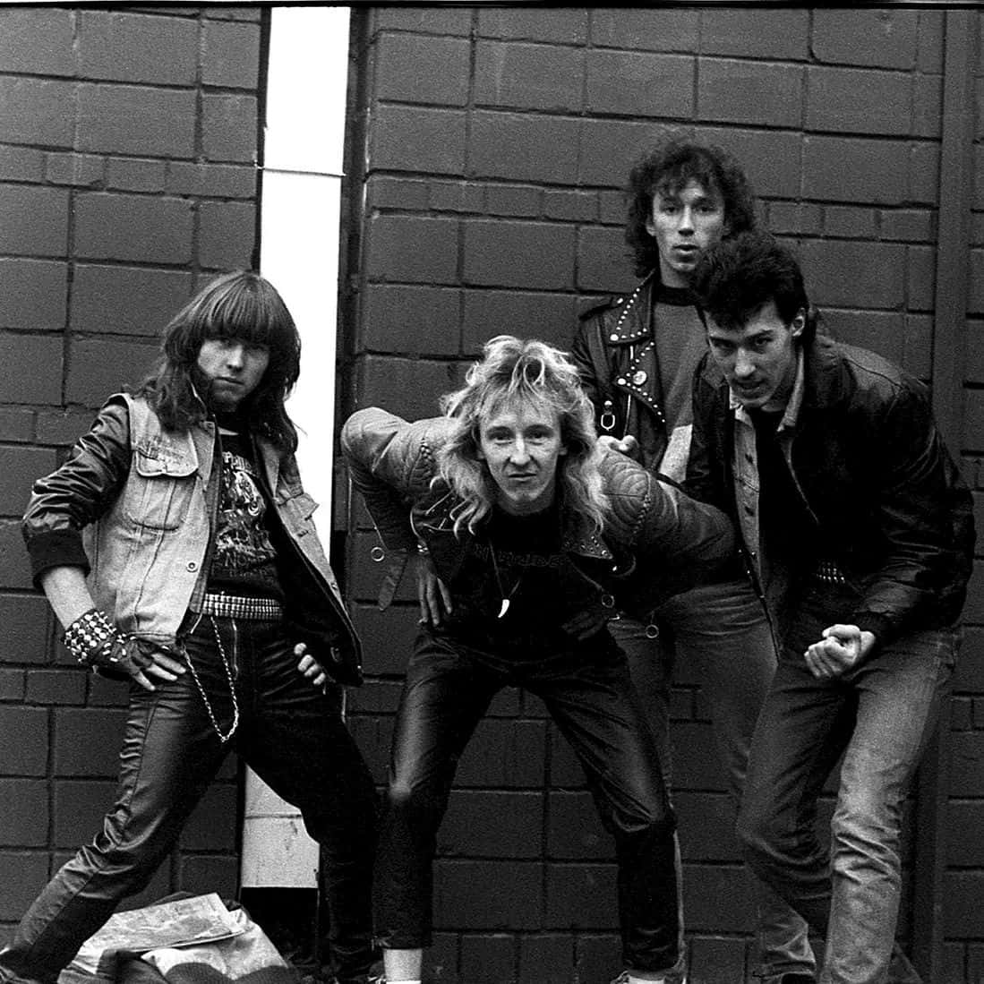 Punk Band Brick Wall Pose Wallpaper