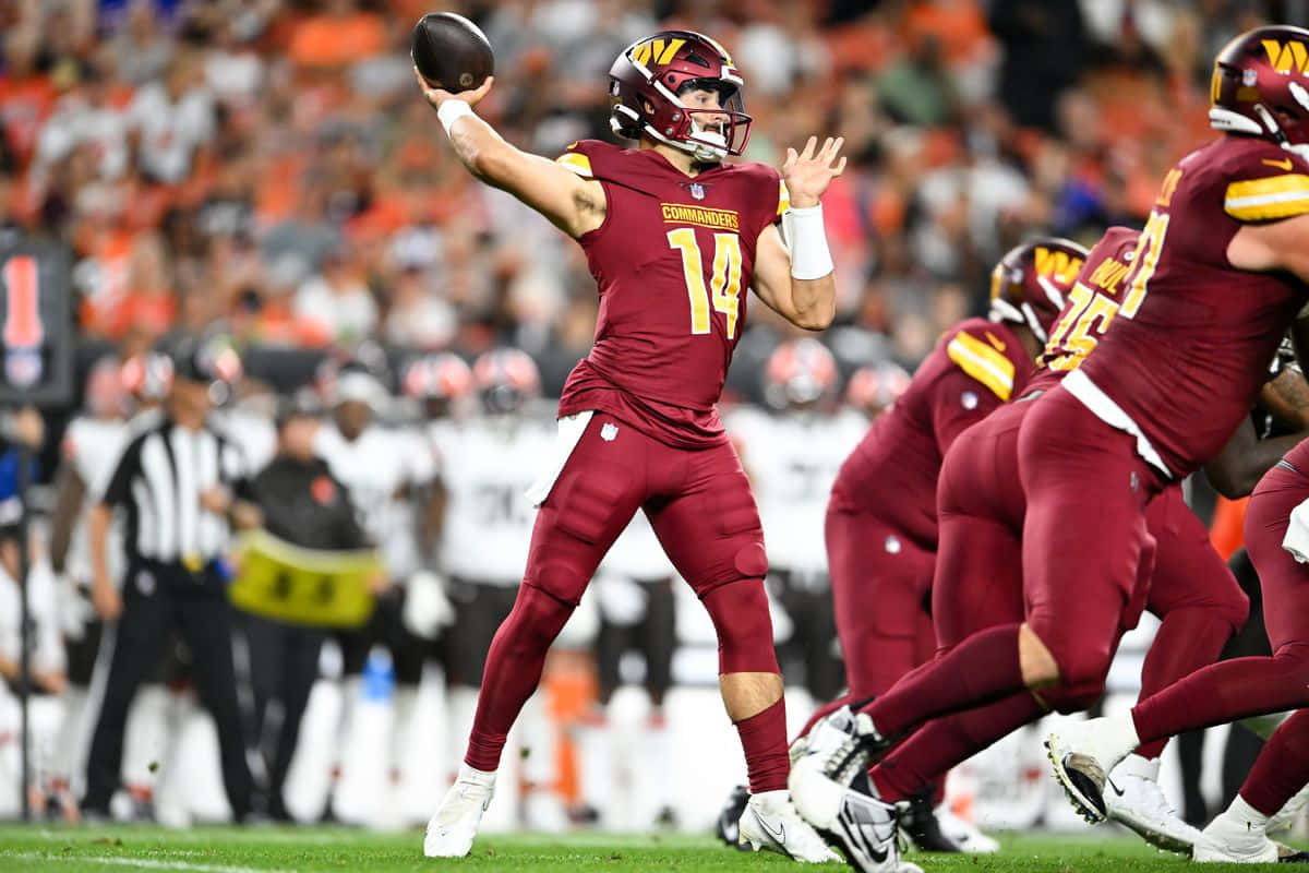 Quarterback Throwing Football During Game Wallpaper