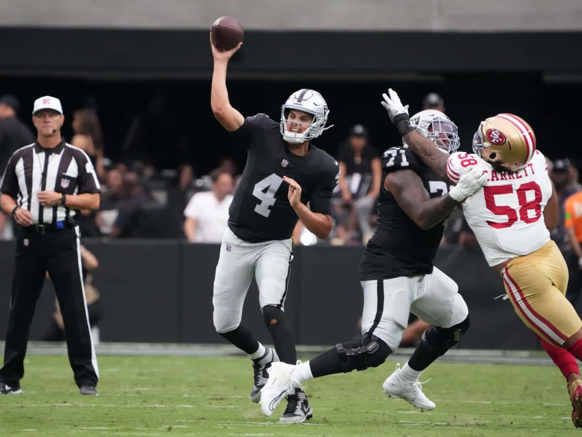 Quarterback Throwing Football During Game Wallpaper