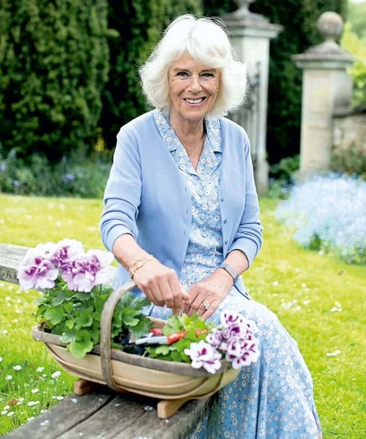 Queen Camilla Gracefully Holding A Flower Basket Wallpaper