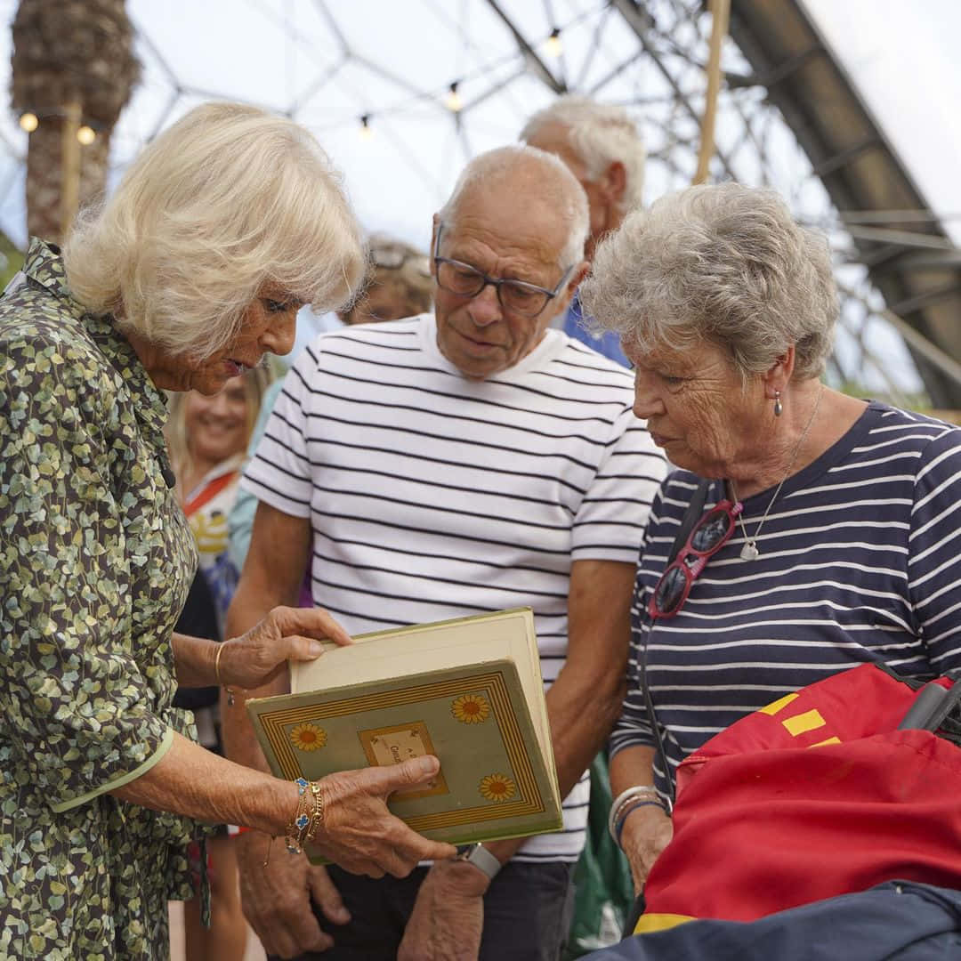 Queen Camilla Looking Through Book Wallpaper