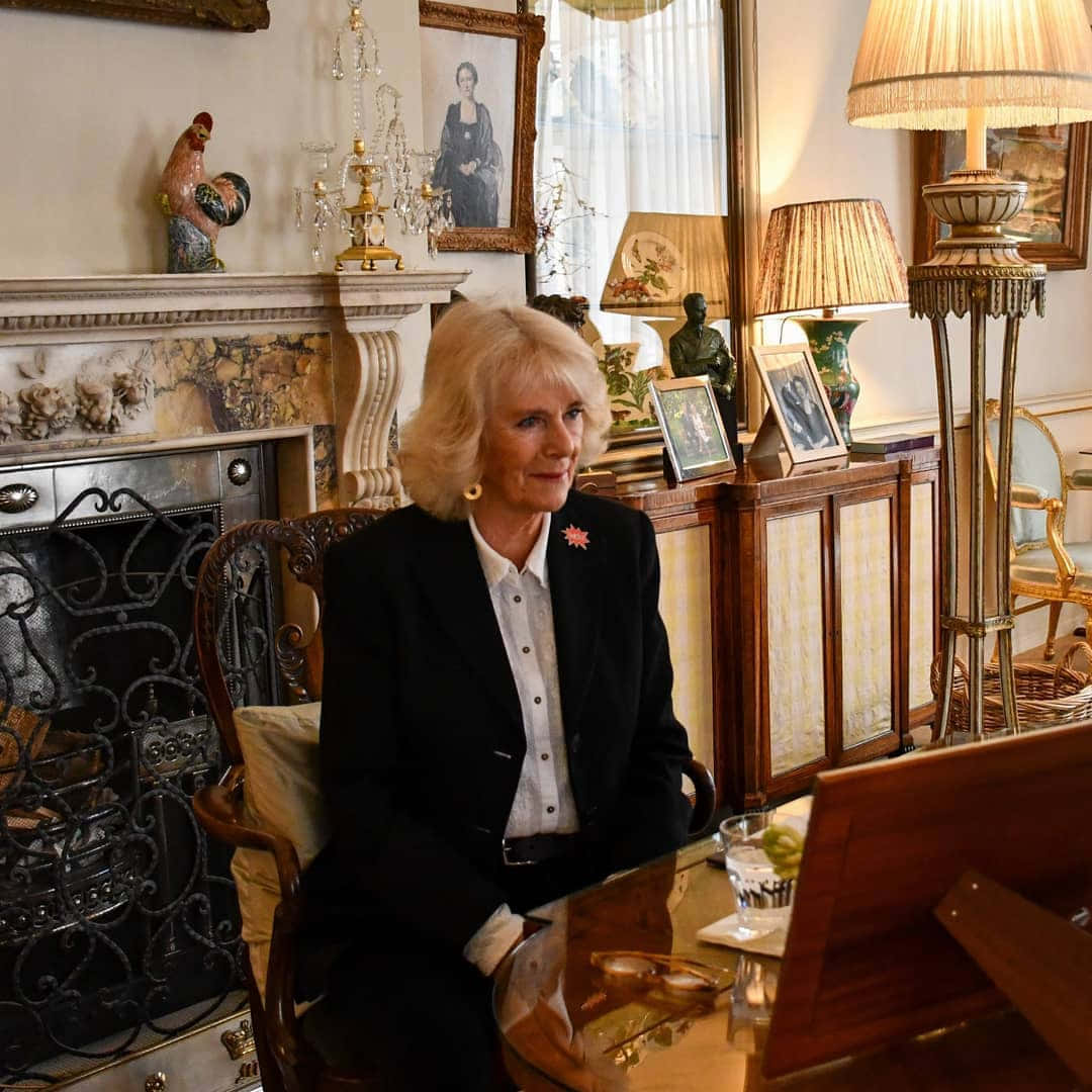 Queen Camilla Sitting Behind Desk Wallpaper