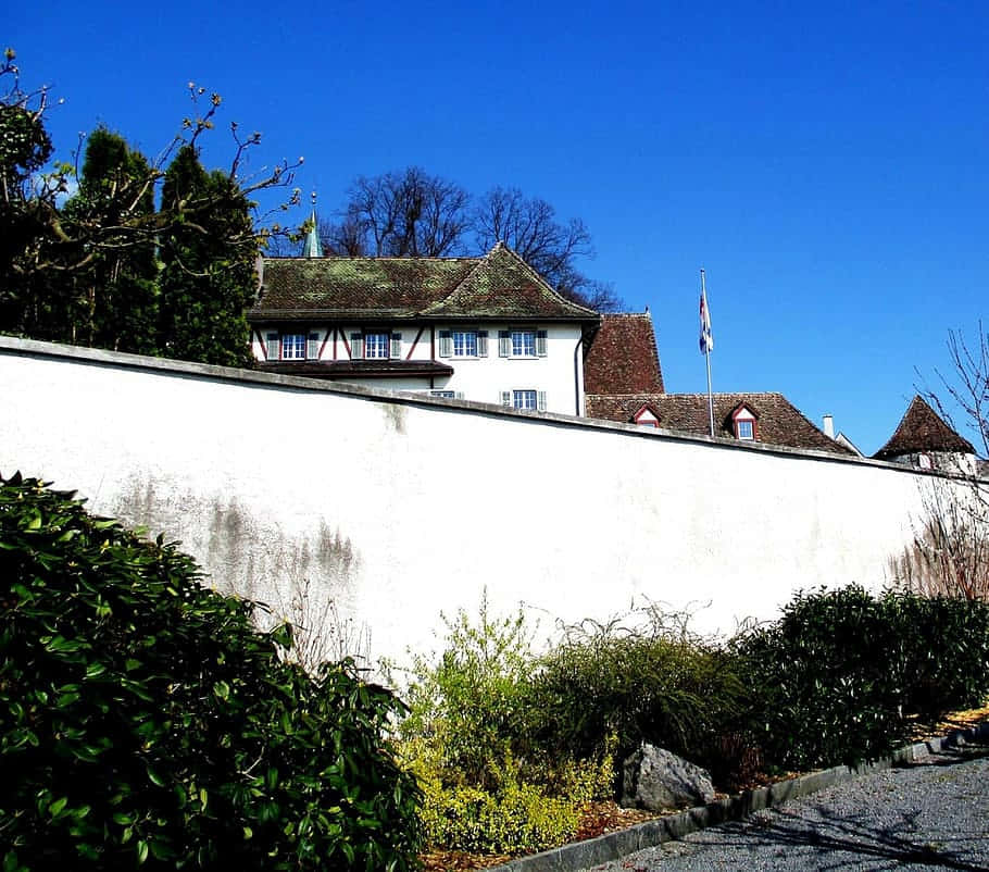 Rapperswil Jona Historic Building Behind White Wall Wallpaper