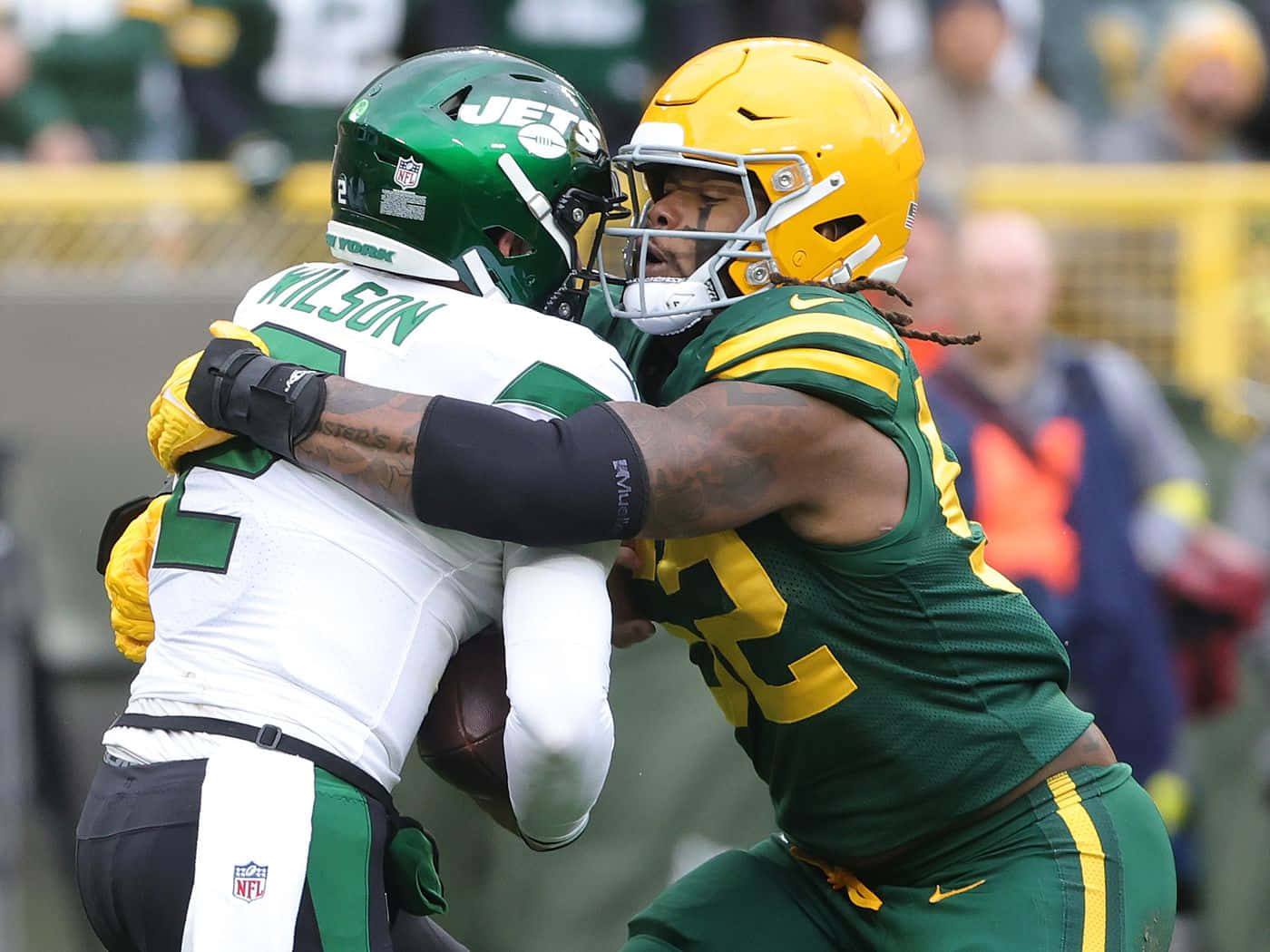 Rashan Gary Tackling Opponent During Game Wallpaper