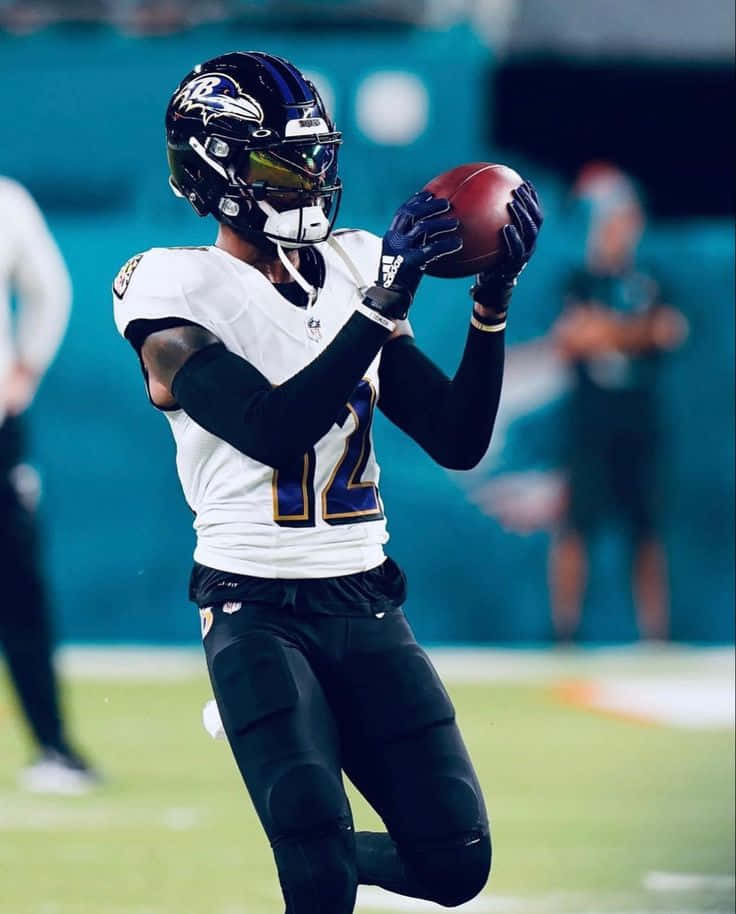 Ravens Player Catching Football Wallpaper