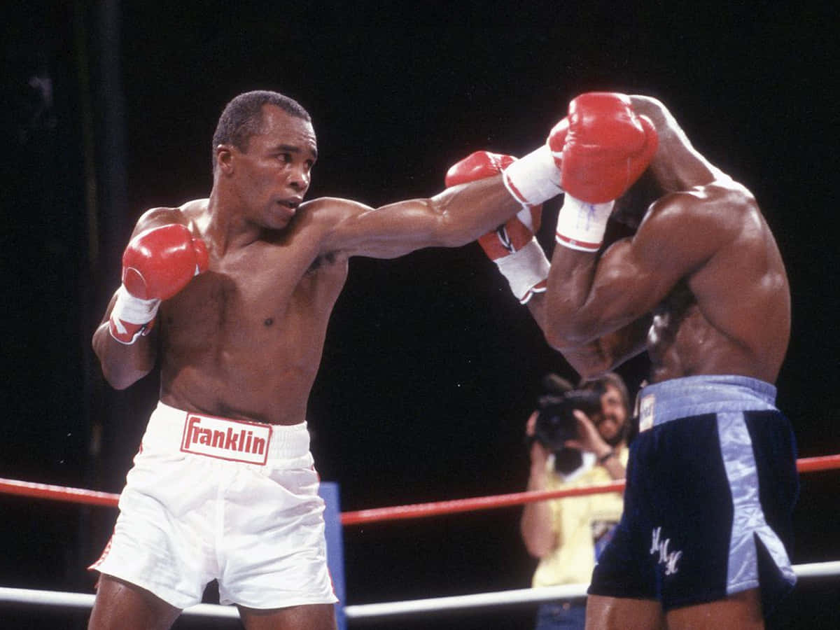 Ray Leonard Breaking Through Opponent's Guard Wallpaper