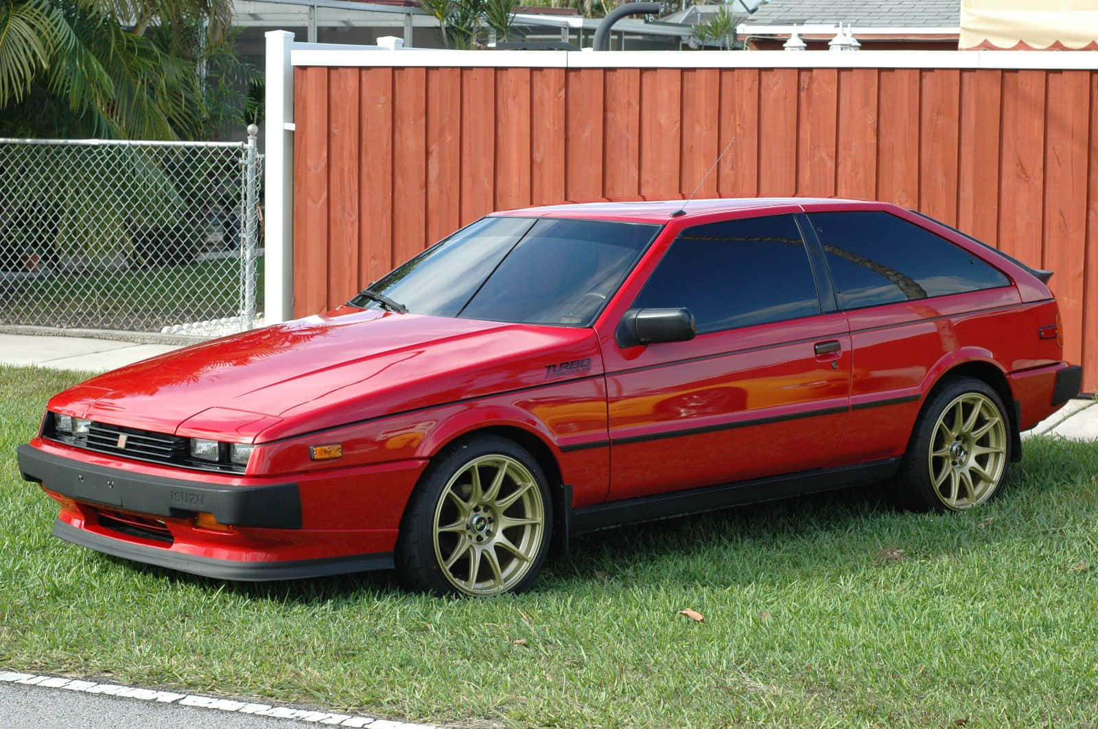 Red Isuzu Impulse Parked Wallpaper