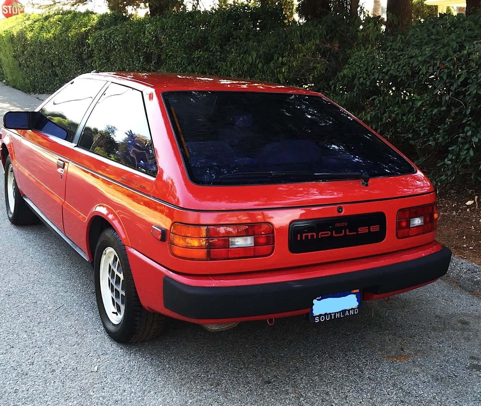 Red Isuzu Impulse Rear View Wallpaper