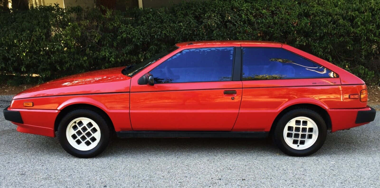 Red Isuzu Impulse Side View Wallpaper