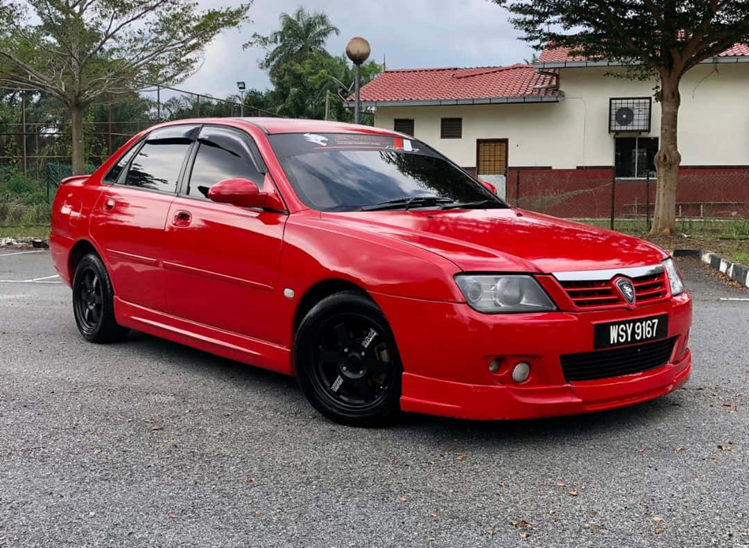 Red Proton Waja Parked Outdoors Wallpaper