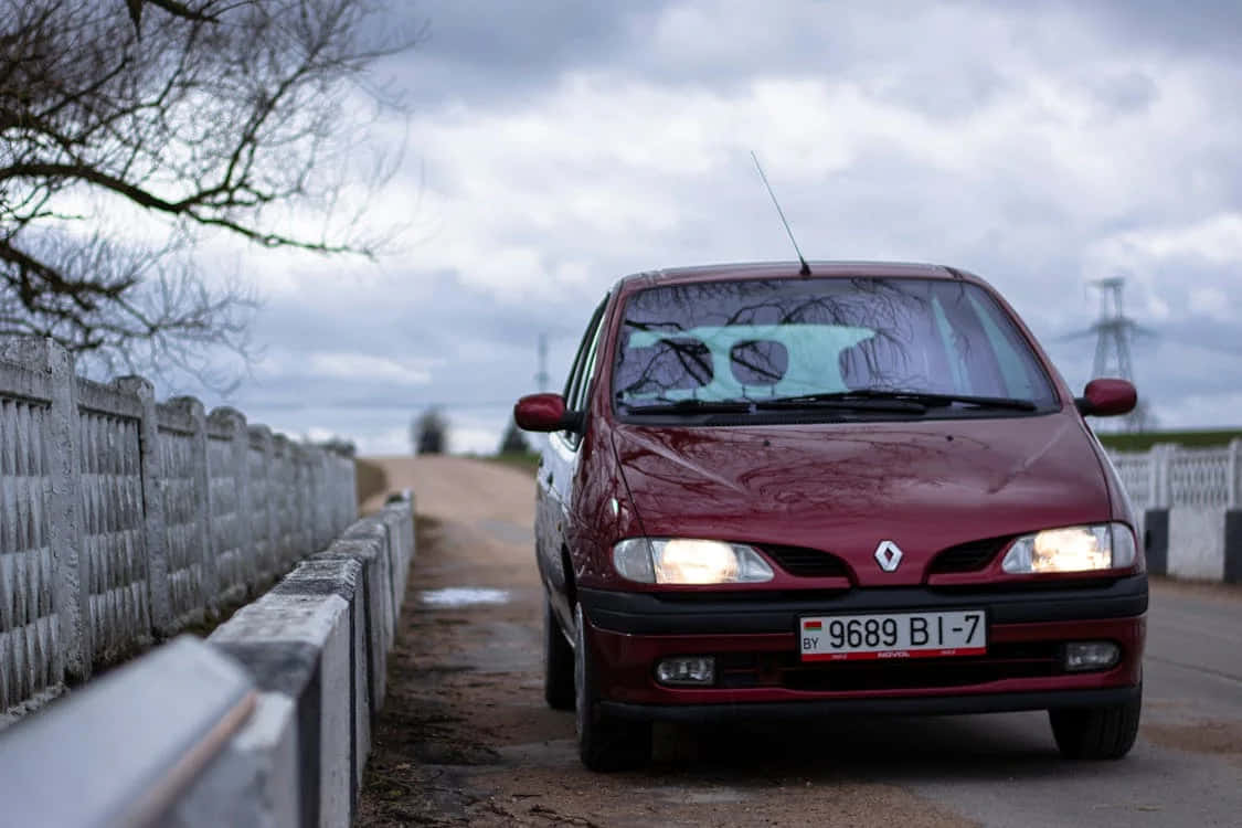 Red Renault Scenic Parked Beside Country Road Wallpaper